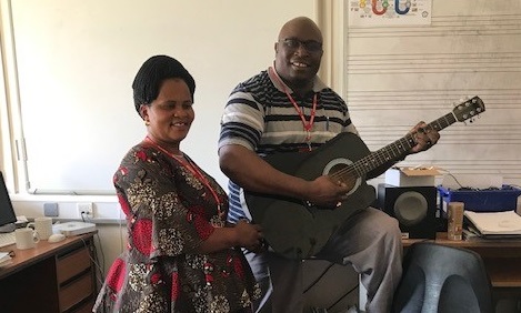 Bishop Vithalis playing the guitar with Monica