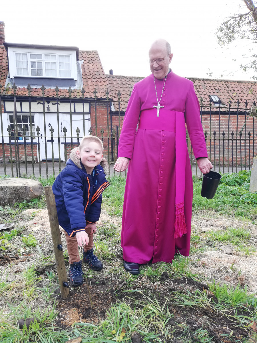 Isaaqx, a pupil at Orford CEVAP School, with Bishop Martin planting a tree after the Lent church service