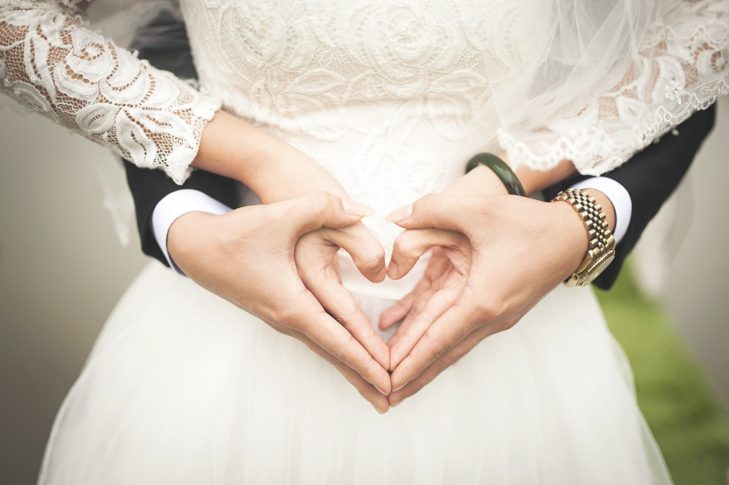 Bride making heart shape with hands